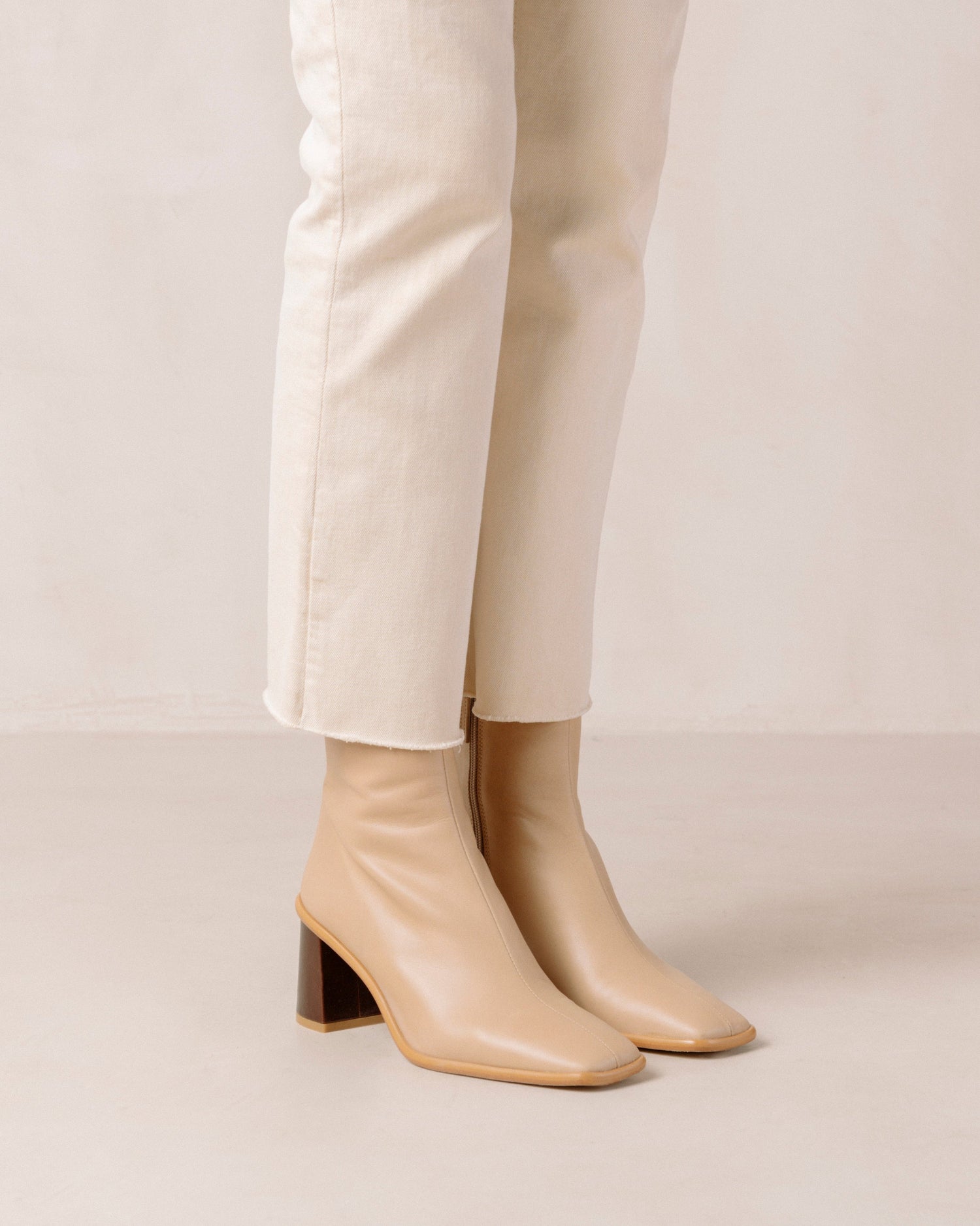 If you don’t know where to go, go West. These sustainable beige boots set atop a contrast block heel, with a slim line silhouette. Defined by their stone wash & square toe, these leather ankle booties also have inward facing zippers for extra comfort and feature a flattering, slim fit.