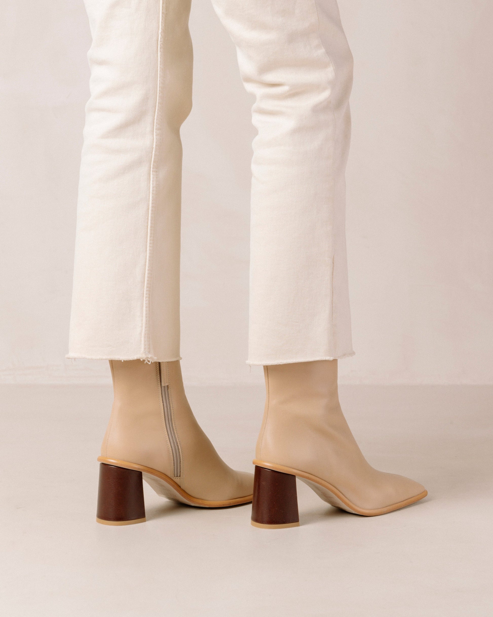 If you don’t know where to go, go West. These sustainable beige boots set atop a contrast block heel, with a slim line silhouette. Defined by their stone wash & square toe, these leather ankle booties also have inward facing zippers for extra comfort and feature a flattering, slim fit.