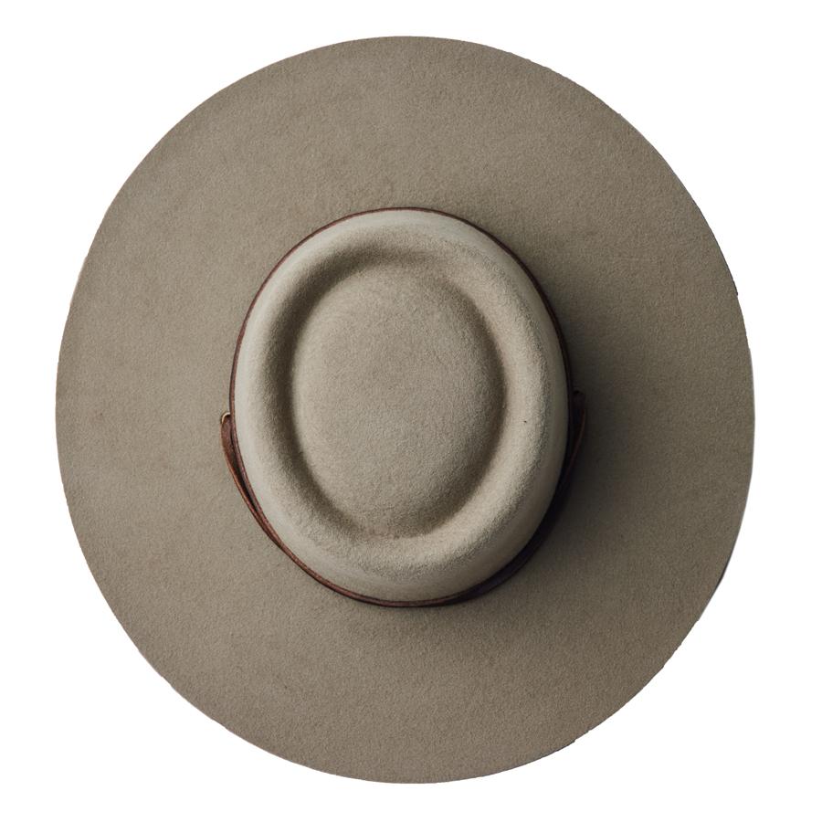 This handcrafted, wool boater hat is made of 100% wool felt with a handmade, veg-tanned leather band. Wool makes for the perfect adventure hat leaving you warm in the winter or dry in the summer.